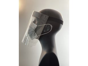 Side profile of the face shield on a mannequin head. Shield starts at the forehead and ends below the chin