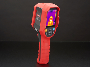 Thermal camera displaying a thermal image on it's lcd screen. Camera is red and grey, with the screen at the top of the camera and a handle at the bottom.