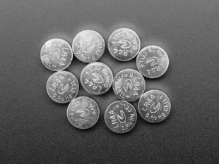Top-down of 10 LR44 / AG13 1.5V Button Cell Batteries.
