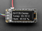 Close up of a Adafruit FeatherWing OLED - 128x64 OLED Add-on For Feather - STEMMA QT / Qwiic. Display reads "AHT20 Demo, Temp:23.22C, Hum: 49.94%"