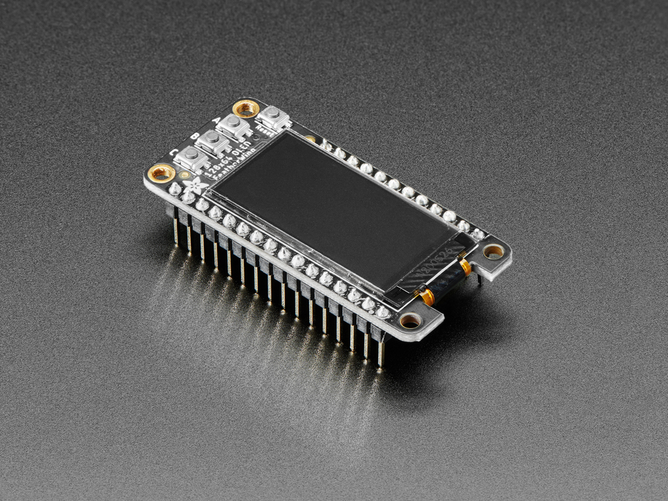 Angled shot of a Adafruit FeatherWing OLED - 128x64 OLED Add-on For Feather - STEMMA QT / Qwiic connected to a set of headers. 