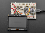 Graphic black and white image on a breakout assembled on a half size breadboard.