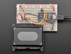 Graphic black and white image on a breakout assembled on a half size breadboard.