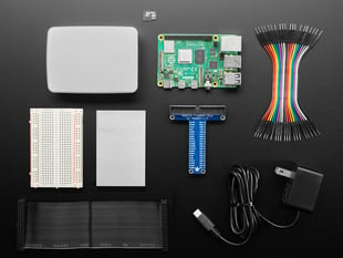 Overhead shot of kit components for a Raspberry Pi Pico budget pack with a Raspberry Pi computer