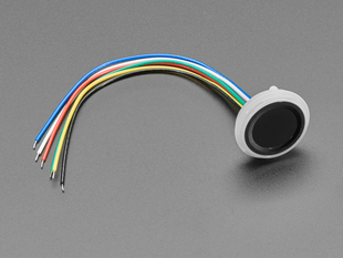 Angled shot of round fingerprint sensor attached to 6-pin cable.