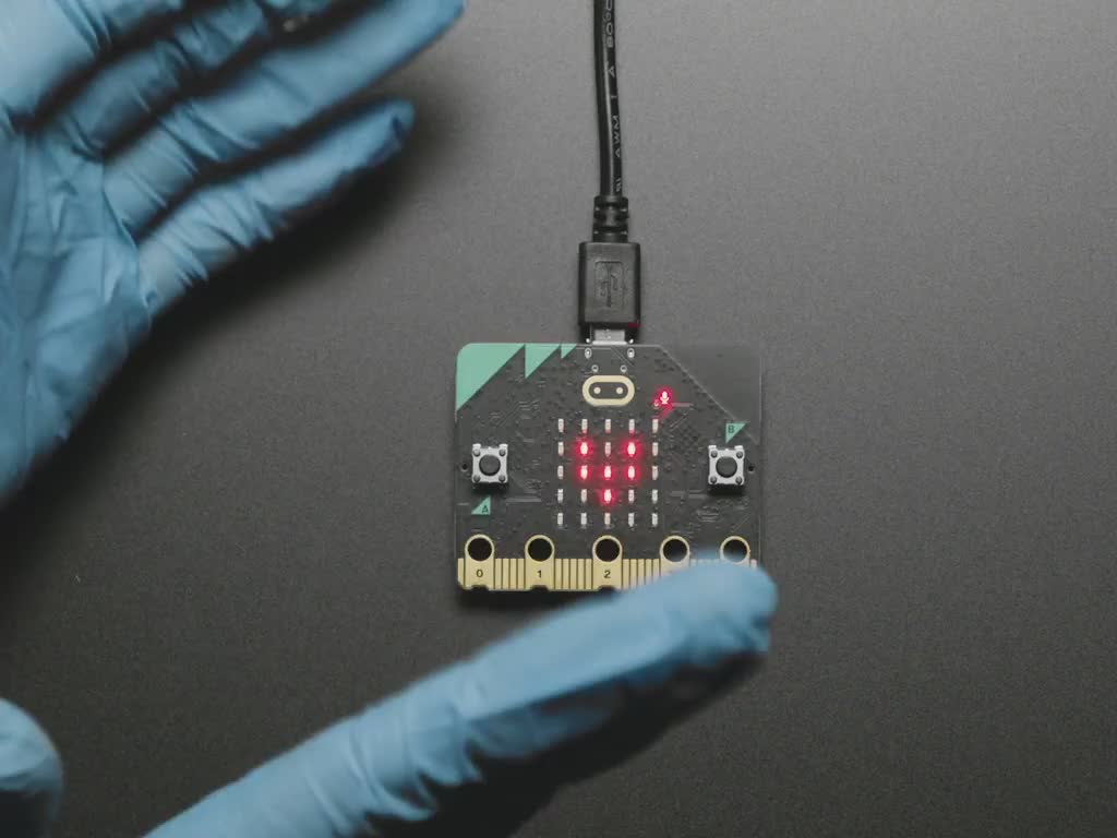 BBC micro:bit v2 with an image of a pulsating heart to the rhythm of clapping hands. 