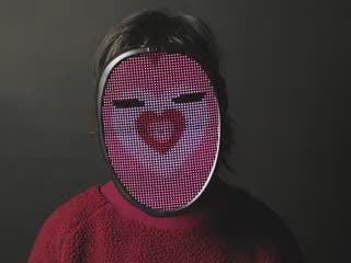 Video of a person wearing LED Matrix Mask. The LED matrix displays a cartoon heart animation.