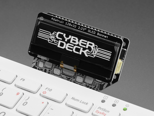 Extreme closeup of black and white OLED display assembled onto Cyberdeck bonnet. The display reads: CYBDERDECK in a cyberpunk font.