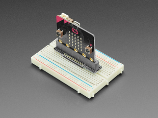Angled shot of a Kitronik Breadboard Breakout for BBC micro:bit connected to a whiteboard and CLUE breakout board