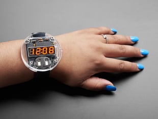 Arm with large round watch with 7 segment display