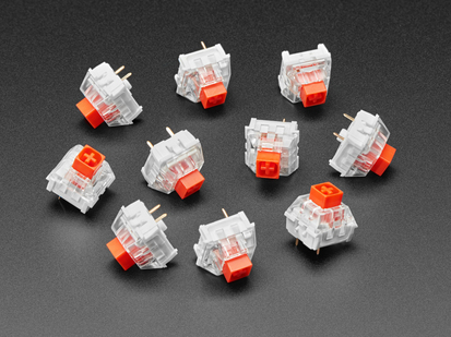 Angled shot of ten red Kailh key switches.