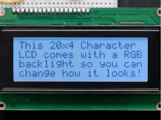 LCD wired on breadboard with backlight changing color with text displayed: "This 20x4 Character LCD comes with an RGB backlight so you can change how it looks".