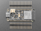 Top view of rectangular microcontroller between two pieces of 16-pin header.