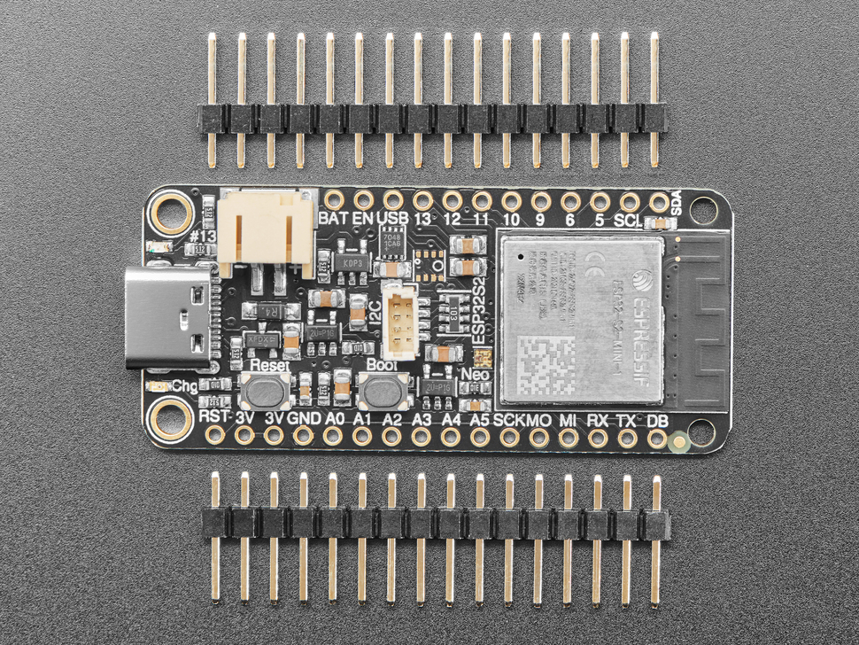 Top view of rectangular microcontroller between two pieces of 16-pin header.