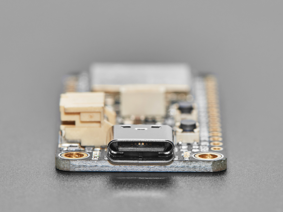 Close-up of USB-C port on rectangular microcontroller.