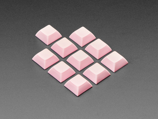 Angled shot of 10 pink plastic keycaps.