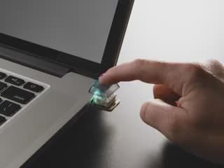 Video of a person pressing the NeoKey Trinkey which emits rainbow colors.