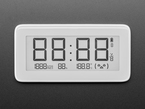 Top view of white rectangular digital clock with electronic ink display. It reads 88:88.