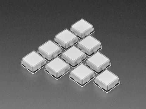 Angled shot of ten white plastic keycaps.