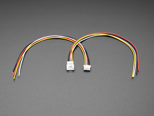 Angled shot of two 2.0mm pitch 4-pin JST PH matching cable pairs. The cables are not connected.