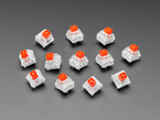 Top view of 12 red kailh key switches.