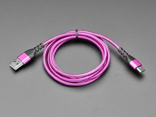 Angled shot of coiled pink and purple USB cable with USB A and USB C connectors.