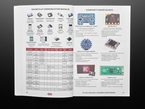 Opened handbook featuring technical pages of parts and components.