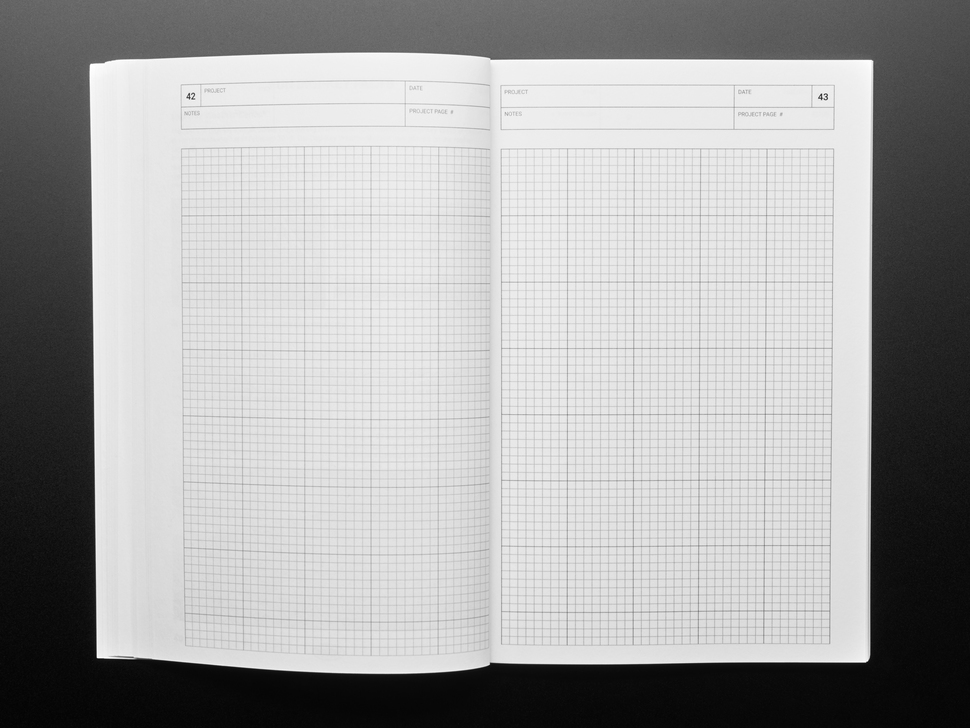 Opened handbook with blank grid pages.