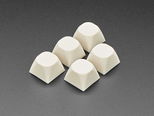 Angled shot of five milky white MA keycap.