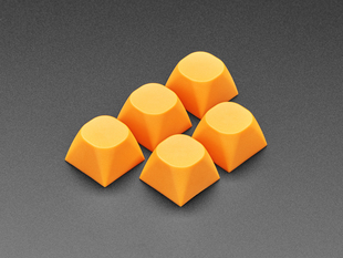 Angled shot of five orange MA keycaps.