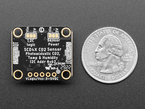 Back of Adafruit SCD-40 - NDIR CO2 Temperature and Humidity Sensor PCB next to US quarter for scale.