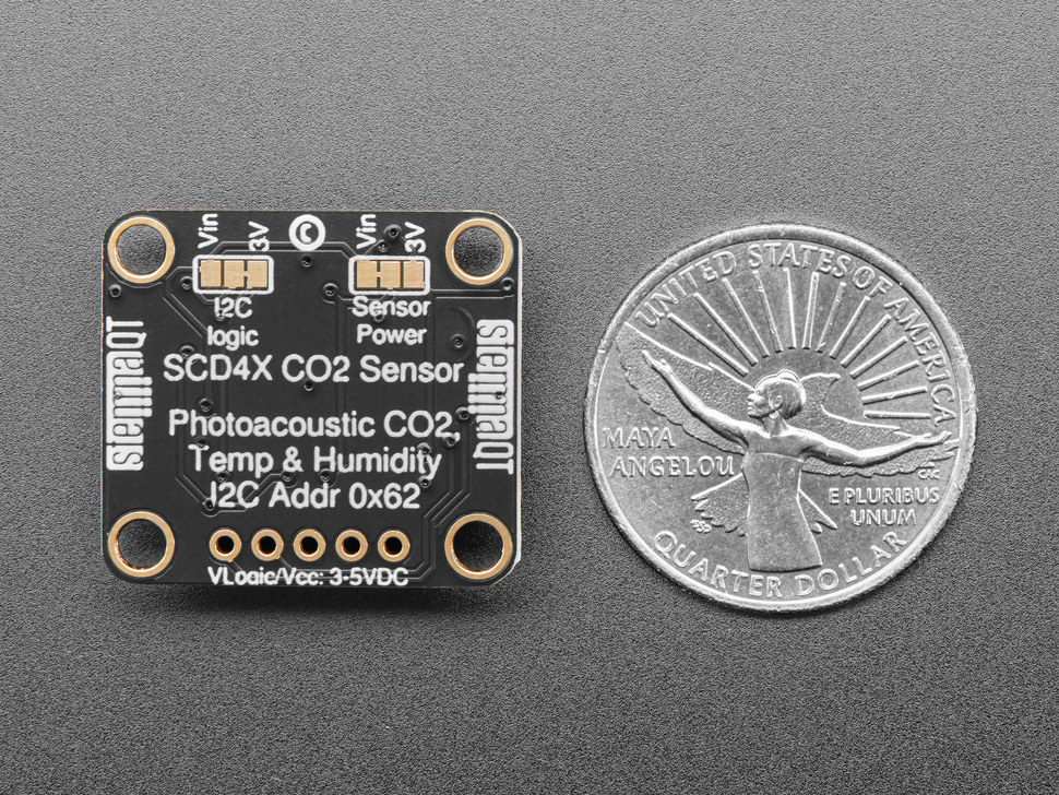 Back of Adafruit SCD-40 - NDIR CO2 Temperature and Humidity Sensor PCB next to US quarter for scale. PCB has Adafruit Pinguin font.