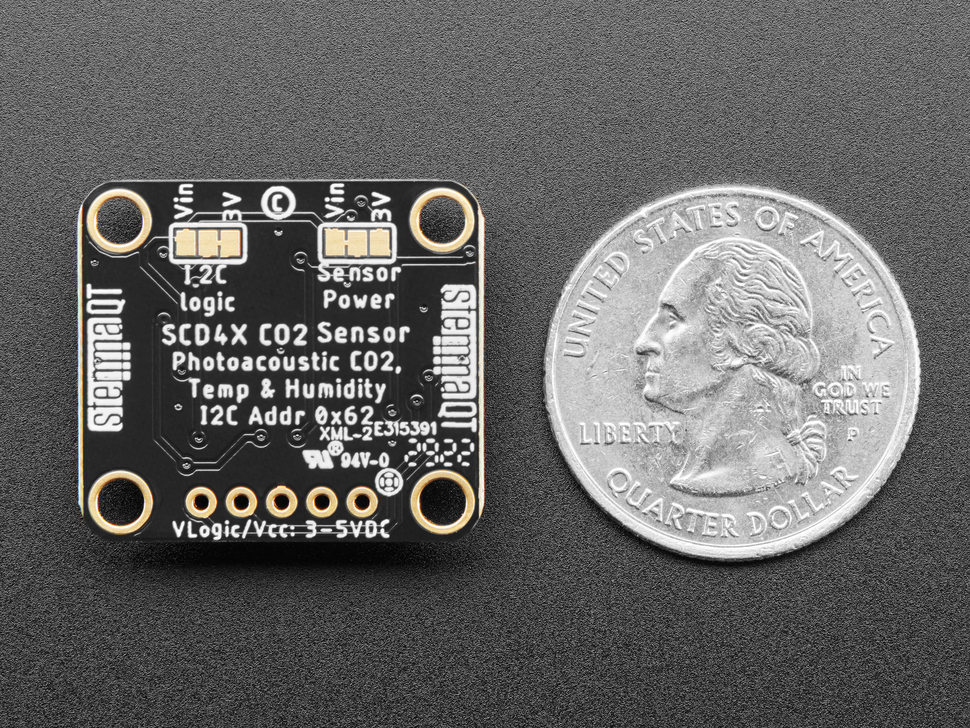 Back of Adafruit SCD-40 - NDIR CO2 Temperature and Humidity Sensor PCB next to US quarter for scale.