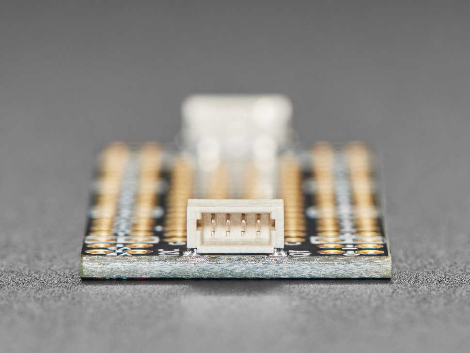 Close-up of tan JST-SH connector on prototyping board.