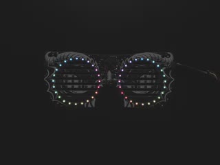 Top view of dragon eyeglass PCB. ADAFRUIT in rainbow LEDs scrolls across the mask.