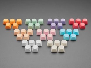 Angled shot of 9 5-packs of different colored MA keycaps.