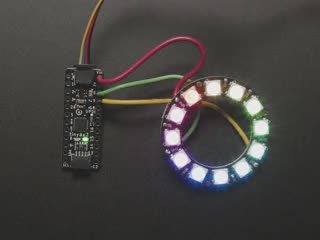 Top view video of a NeoPixel ring soldered with wires to an Adafruit ATtiny817 Breakout. The NeoPixel ring glows rainbow colors.