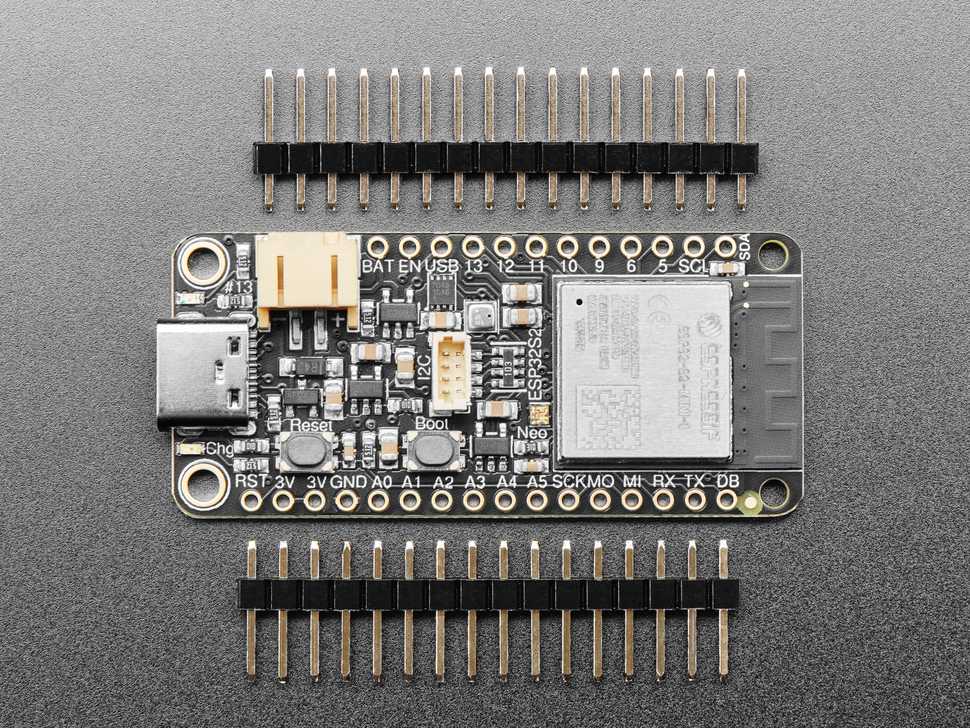 Top view of rectangular microcontroller surrounded by two pieces of 16-pin header.