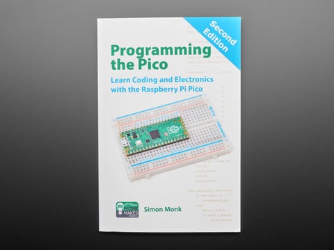 Front cover of technical book: "Programming the Pico. Learn Coding and Electronics with the Raspberry Pi Pico." Cover art is an angled photograph of a long green rectangular microcontroller assembled into a half-size breadboard.