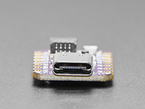 Close-up of USB-C connector on small square dev board.