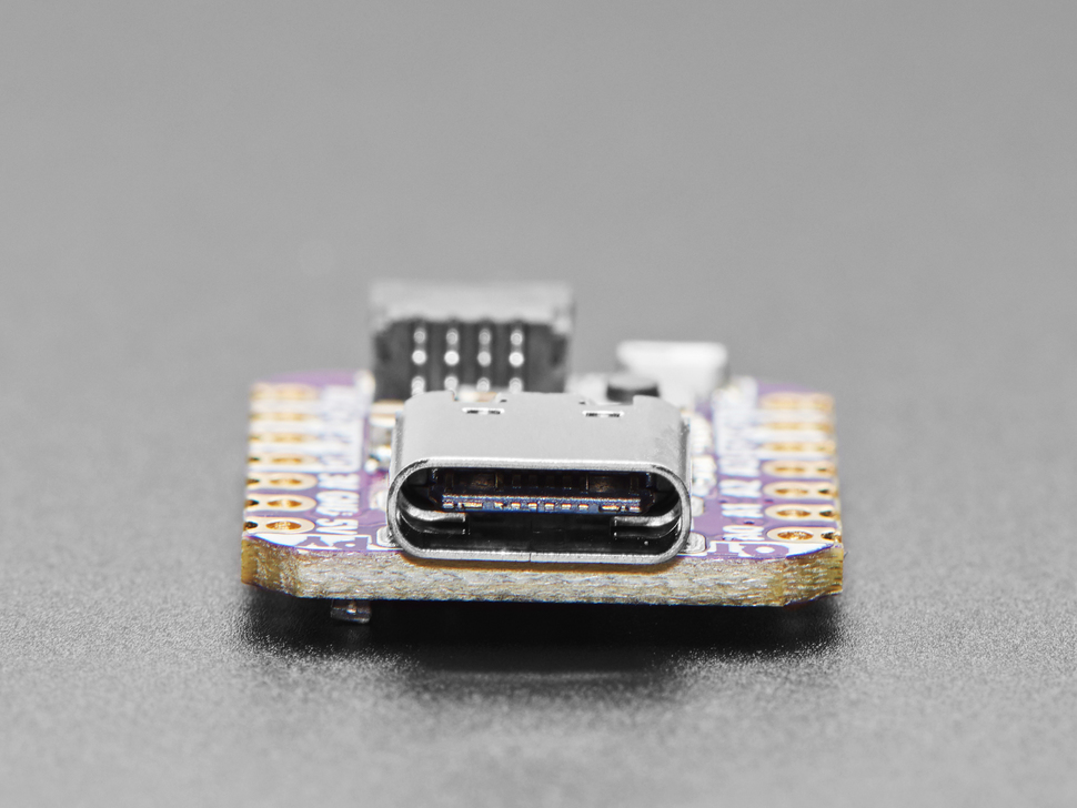 Close-up of USB-C connector on small square dev board.