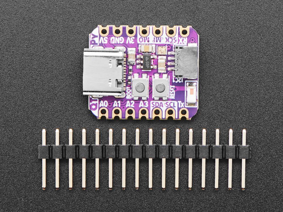 Top view of small square dev board above a piece of 14-pin header.