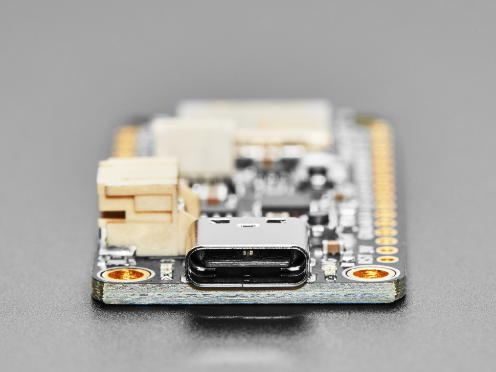 Side detail of black rectangle-shaped microcontroller featuring USB-C connector.