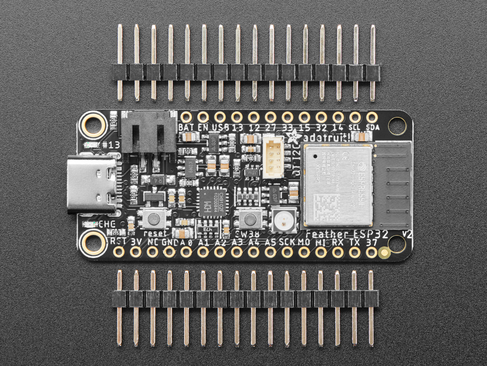 Top view of black rectangle-shaped microcontroller between two pieces of 16-pin 0.1" header.