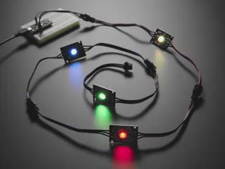 Video of four chained LED PCBs glowing rainbow colors.