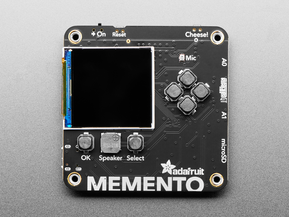 Overhead shot of black, square-shaped camera board with TFT display and buttons.