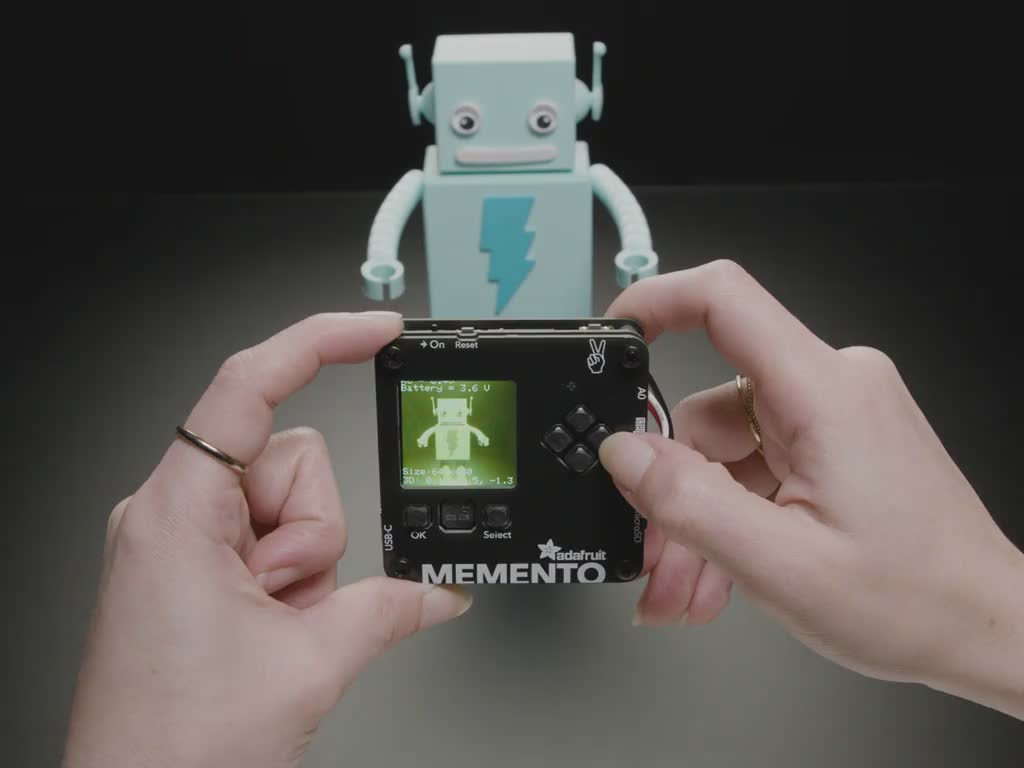 Video of friendly robot character on a monitor on a small, DIY camera.
