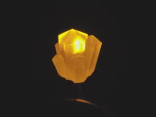 Video of a crystal-shaped LED emitting yellow light.