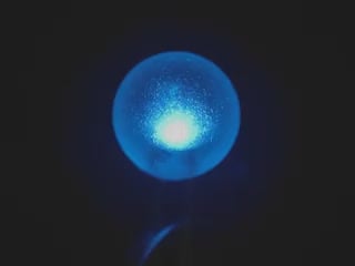 Video of a sphere-shaped LED emitting blue light.