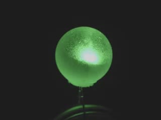 Video of a spherical LED emitting green light.